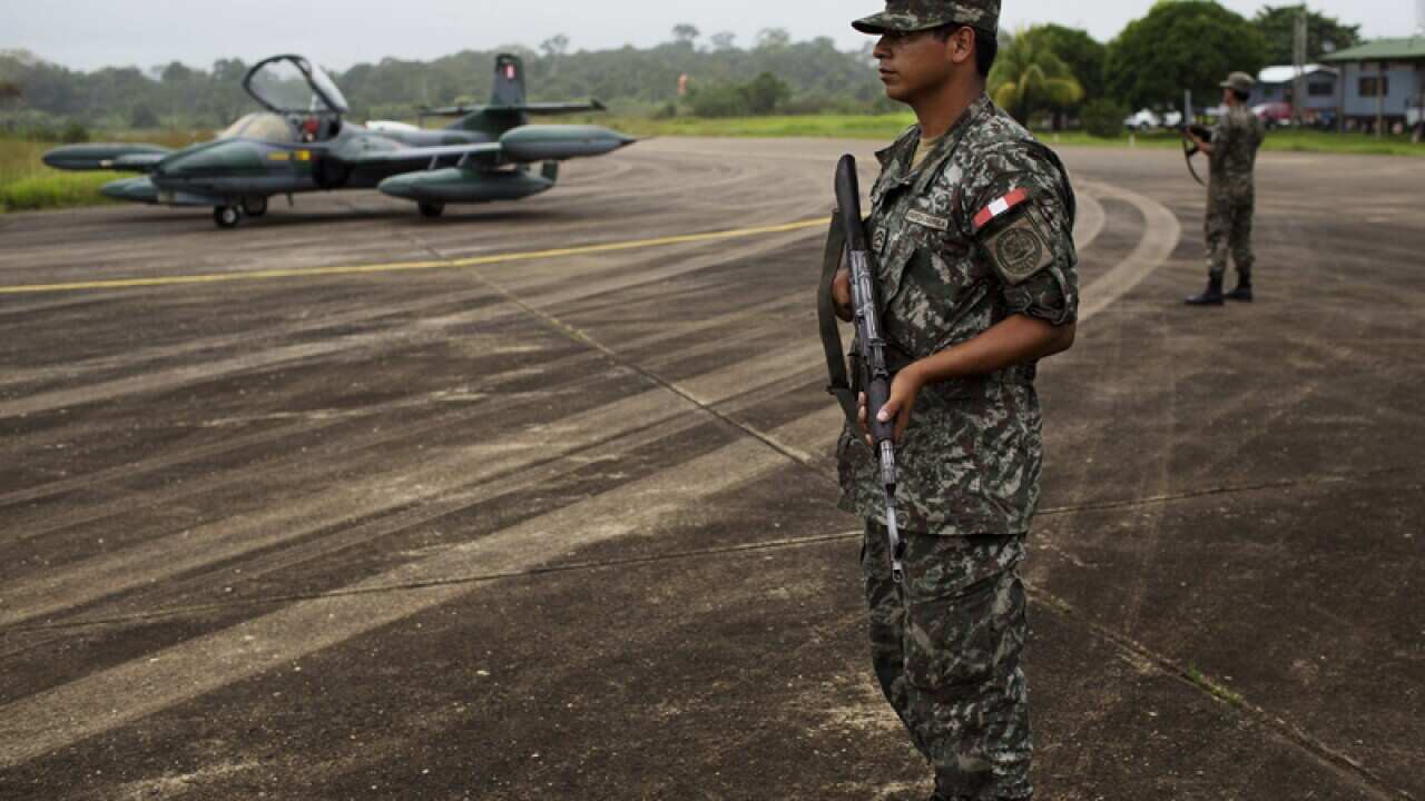 Soldiers stand guard at a military base in Madre de Dios, Peru