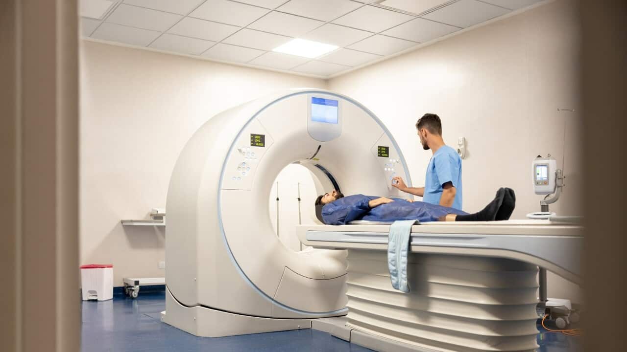 Doctor getting a patient ready for a medical scan at the hospital