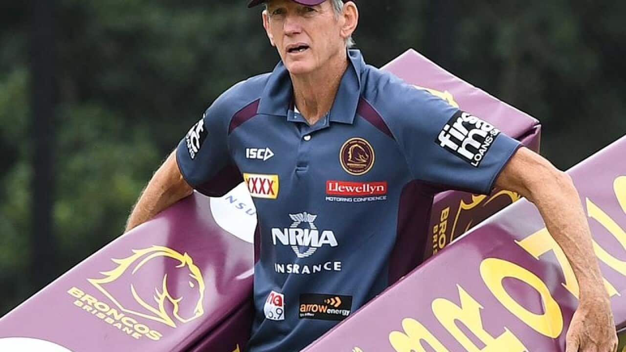 File image of Brisbane NRL coach Wayne Bennett carrying post pads.