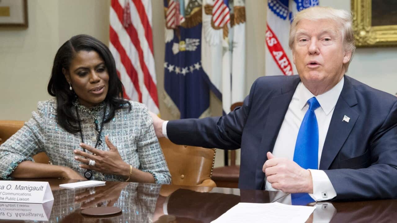 US President Donald J. Trump (R) speaks beside then Director of Communications for the Office of Public Liaison Omarosa Manigault-Newman (L)