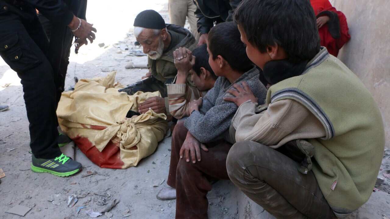 Syrian children mourn the death of their mother following an air strike by government forces on the Syrian city of Aleppo getty.jpg