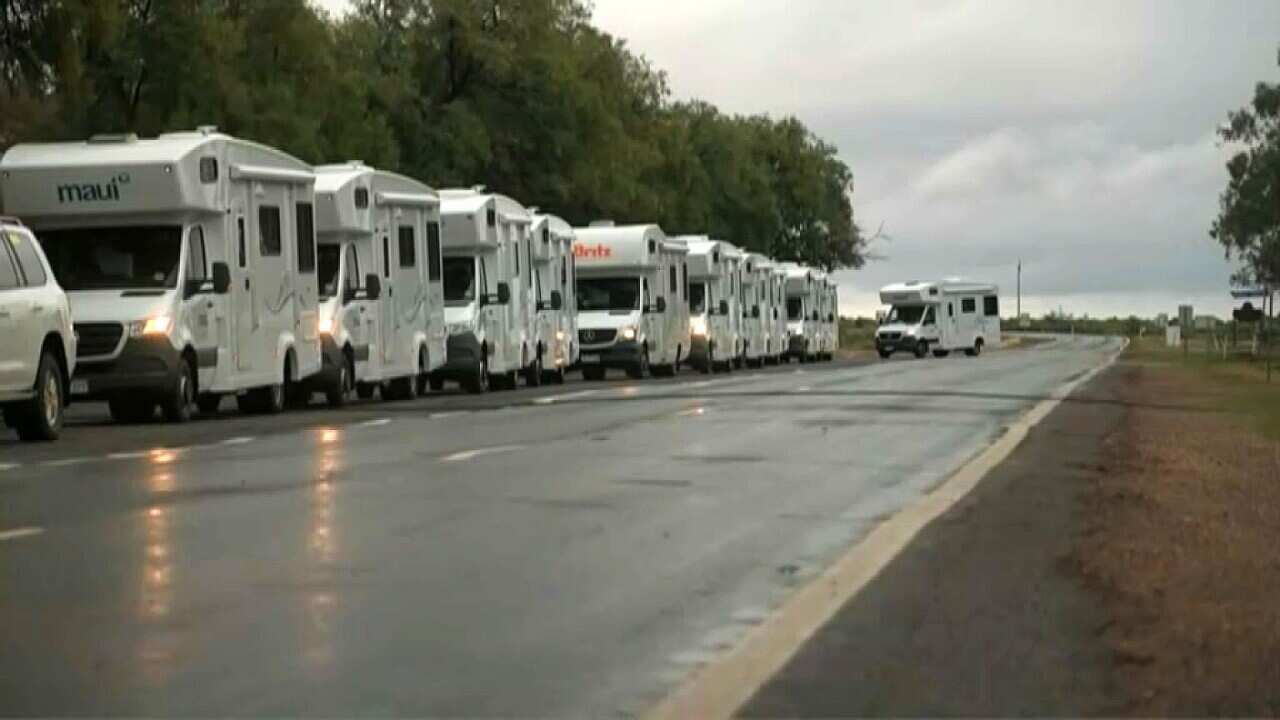 Mobile homes queue to enter Wilcannia where they will be used as temporary accommodation