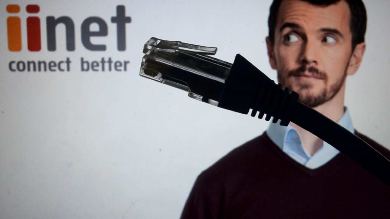 An ethernet cable is seen in front of the logo of iiNet