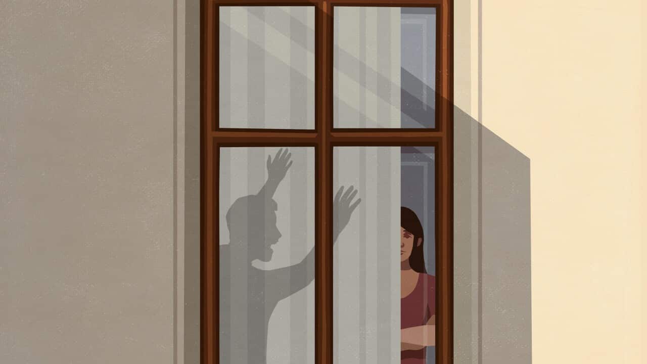 Shadow of angry man gesticulating at woman in apartment window
