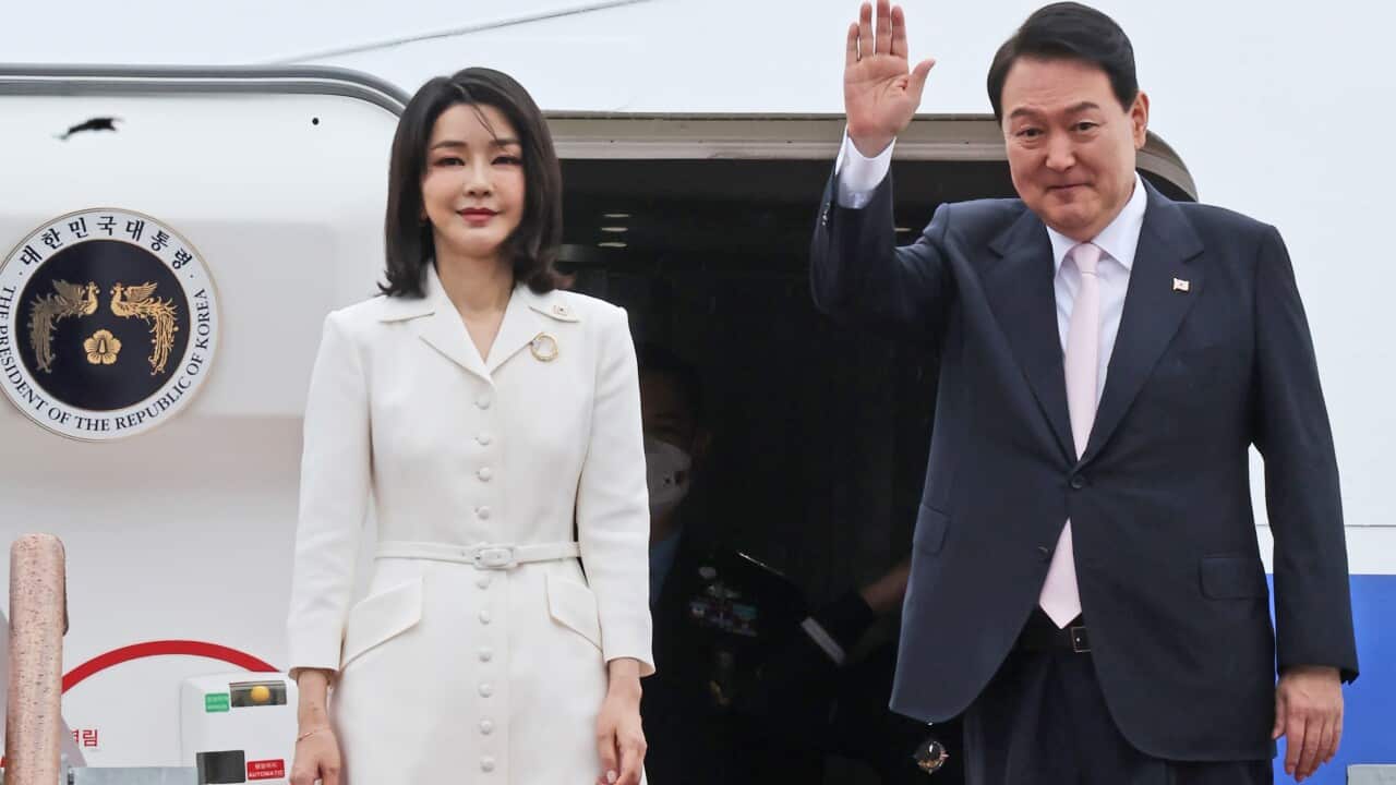 South Korean President Yoon Suk Yeol, right, waves as his wife Kim Keon Hee stands before departing for Spain to attend the 2022 NATO summit, at the Seoul military airport in Seongnam, South Korea, Monday, June 27, 2022. (Ahn Jung-won/Yonhap via AP)
