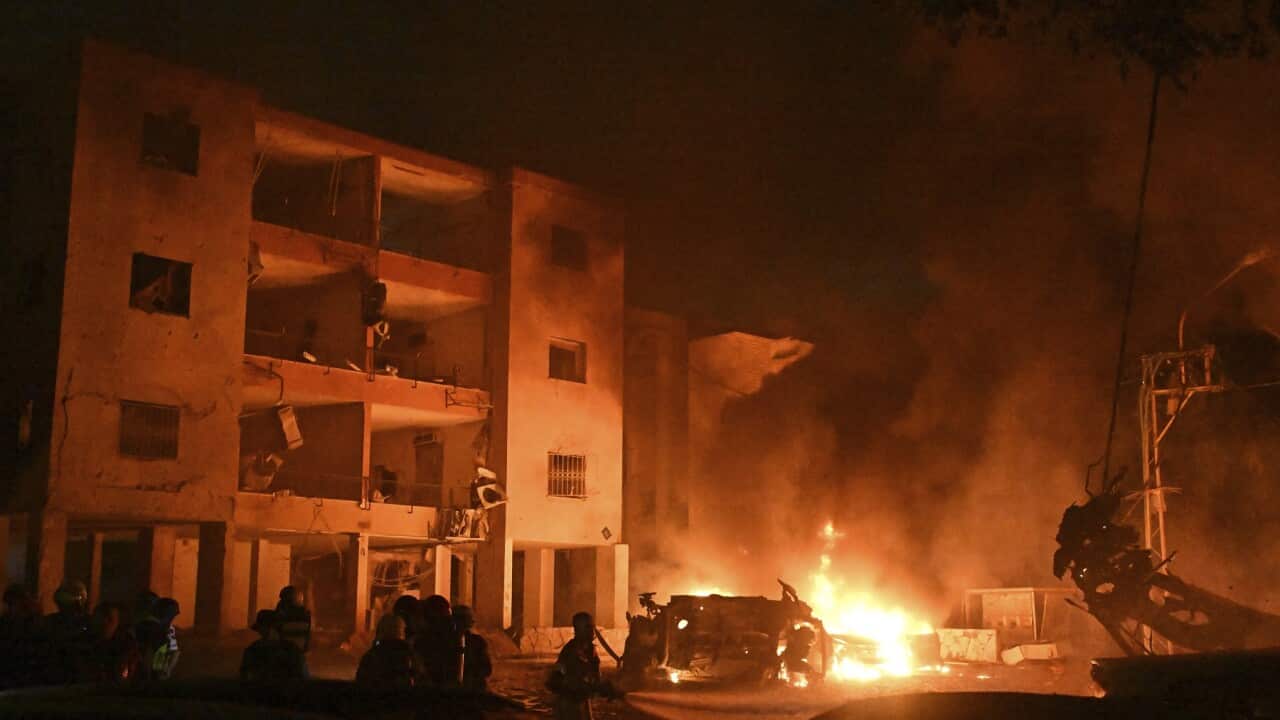 Firefighters work to extinguish a blaze after a missile launched from Iran struck Haifa, in northern Israel (AAP),
