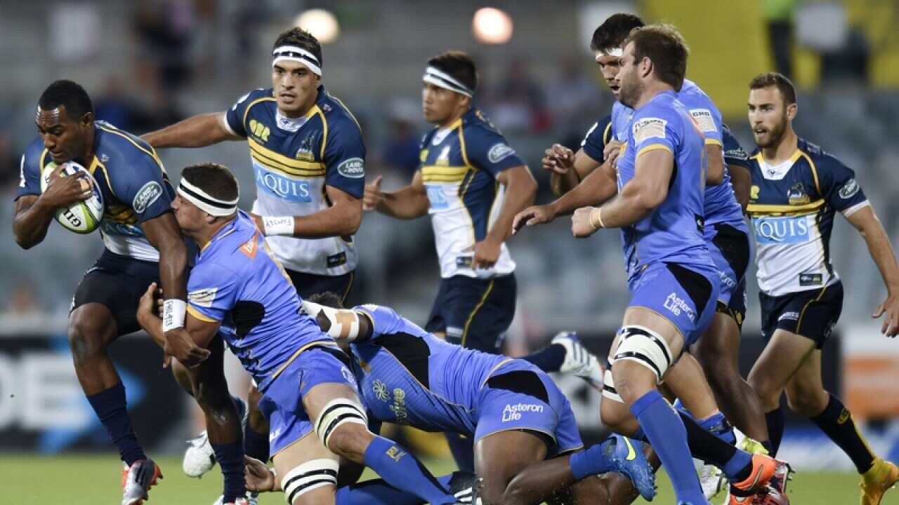Brumbies' Tevita Kuridrani (L) is tackled by Force's Ben McCalman