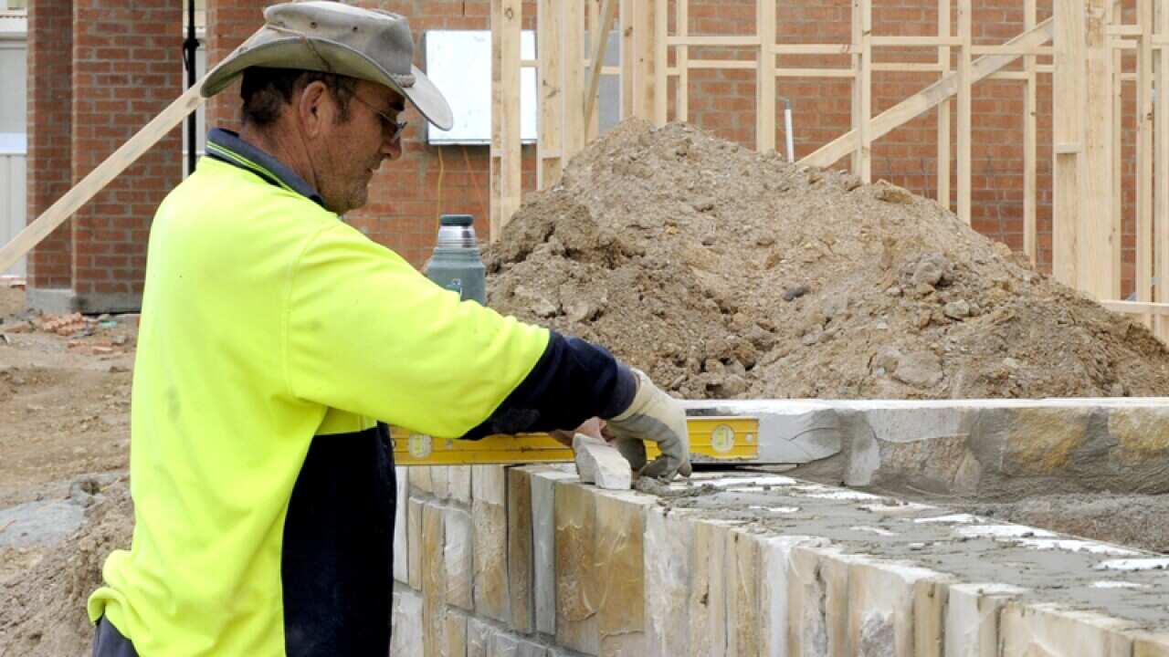A stonemason at work on a new home
