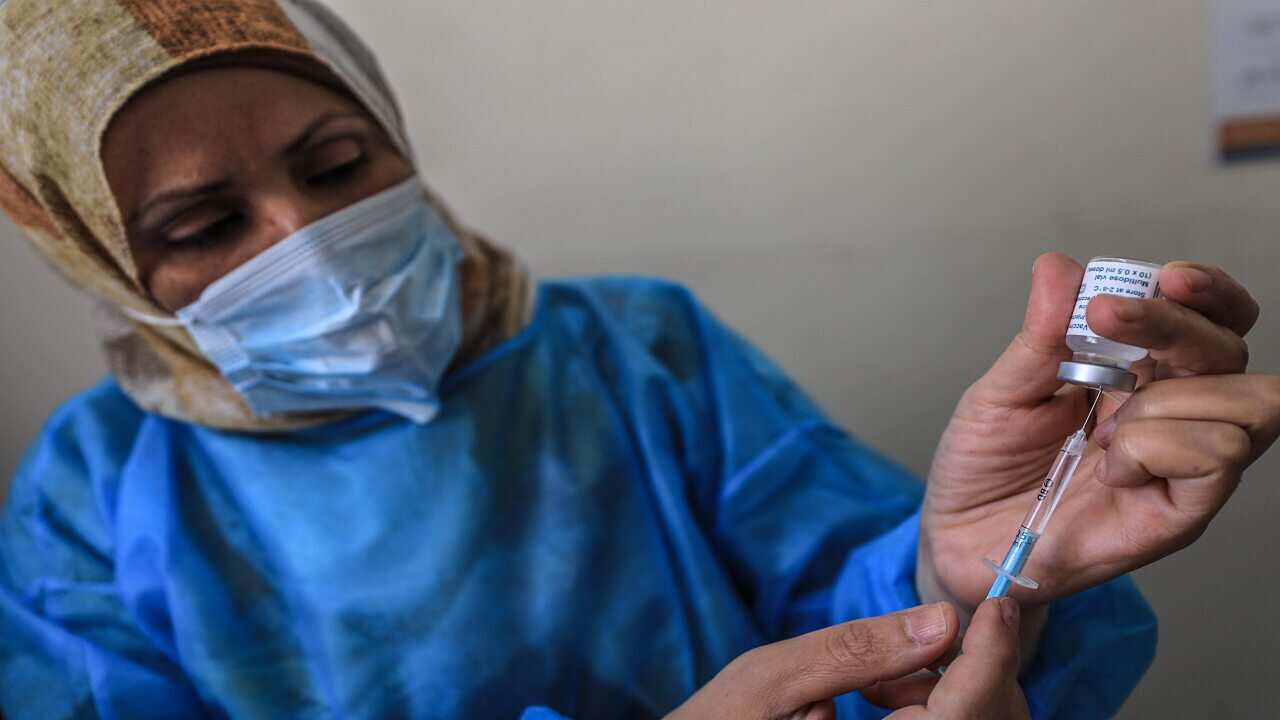 A Palestinian medical worker prepares a COVID-19 vaccine, at the Ministry of Health's Sabha Al-Harazeen clinic in the east of Gaza City, 27 May 2021.