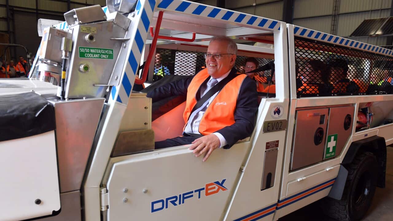Prime Minister Scott Morrison inside an electric vehicle at an engineering facility specialising in renewable technology during a visit to the Hunter Valley, Monday, November 8, 2021. (AAP Image/Mick Tsikas) NO ARCHIVING