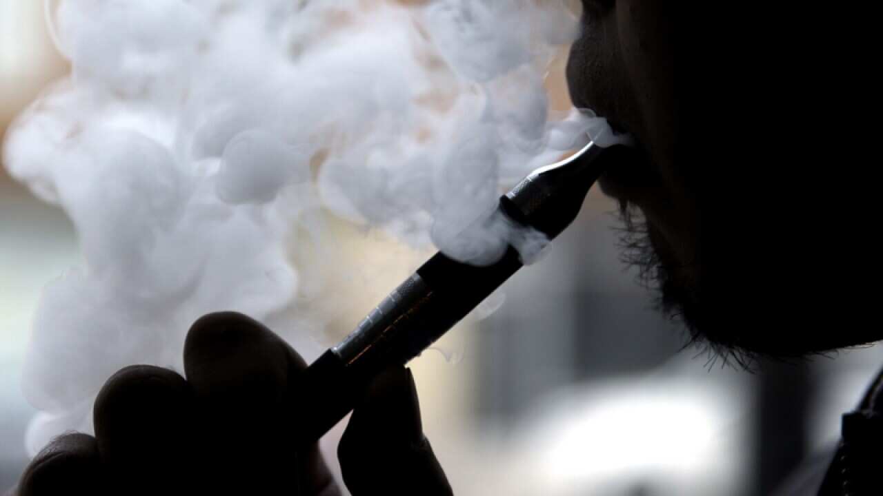 Daryl Cura demonstrates an e-cigarette