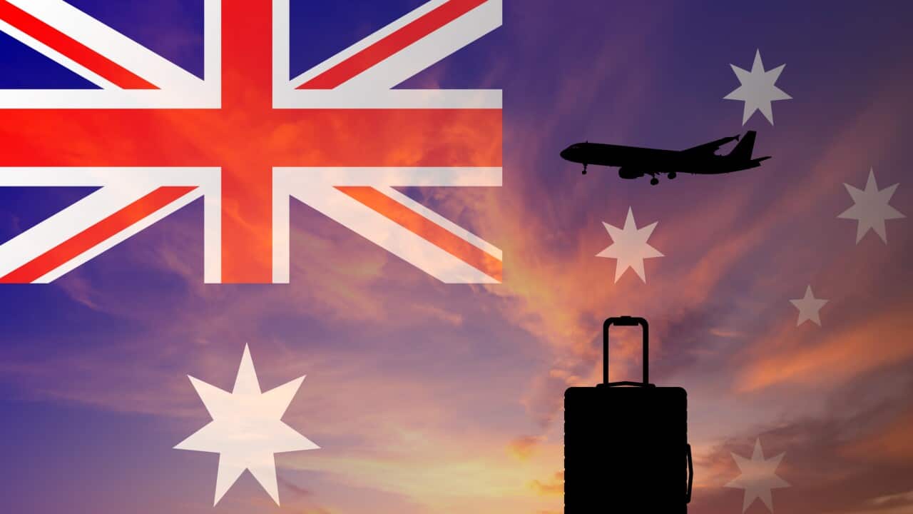 Suitcase and airplane against the background of the Australian flag