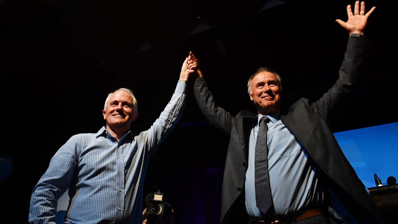 Malcolm Turnbull and Liberal member for Bennelong John Alexander celebrate at a by-election night party.