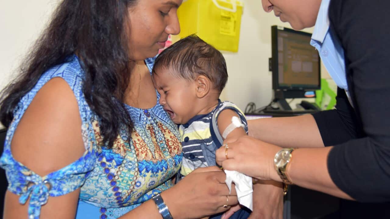 A child cries while getting the vaccine in the Northern Territory (AAP)