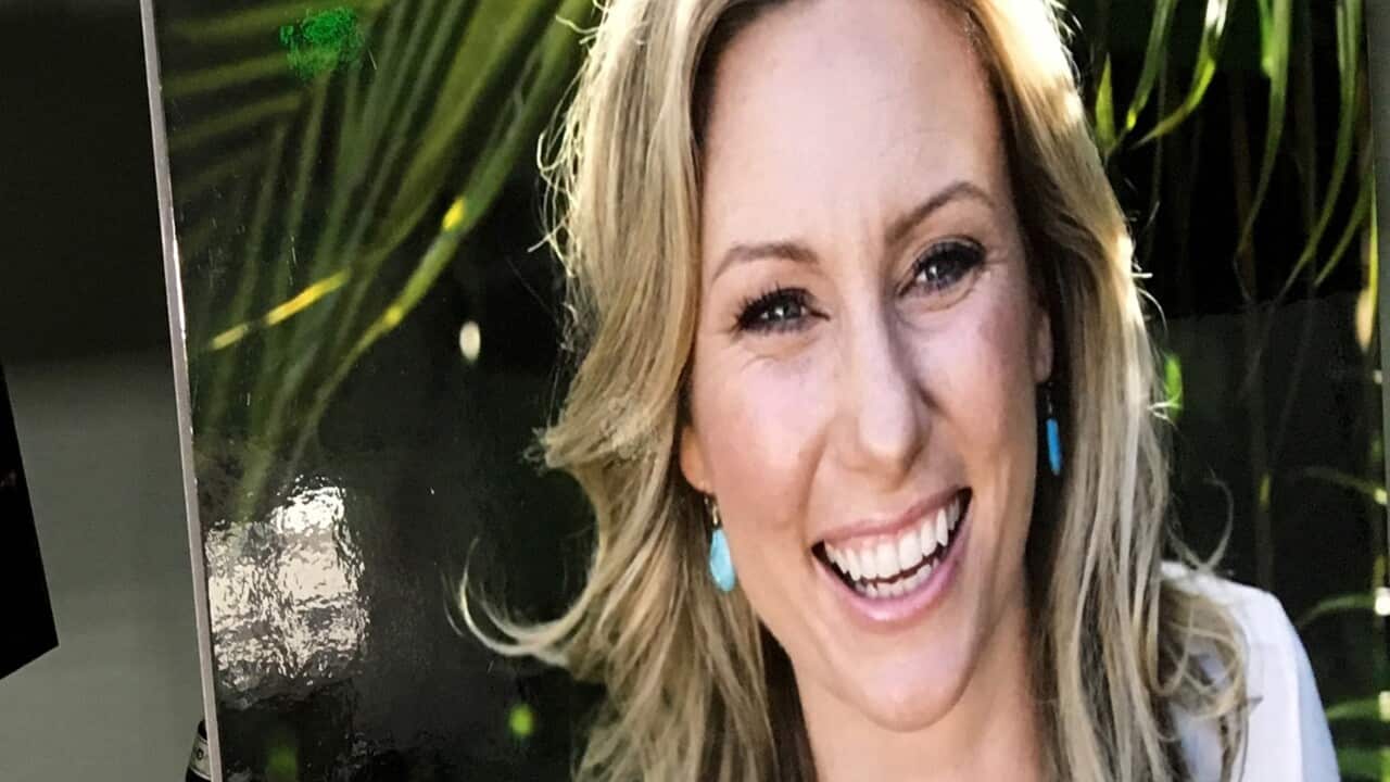 In this July 23, 2018, file photo, a poster of Justine Damond Ruszczyk is displayed at a news conference by attorneys for her family in Minneapolis. 