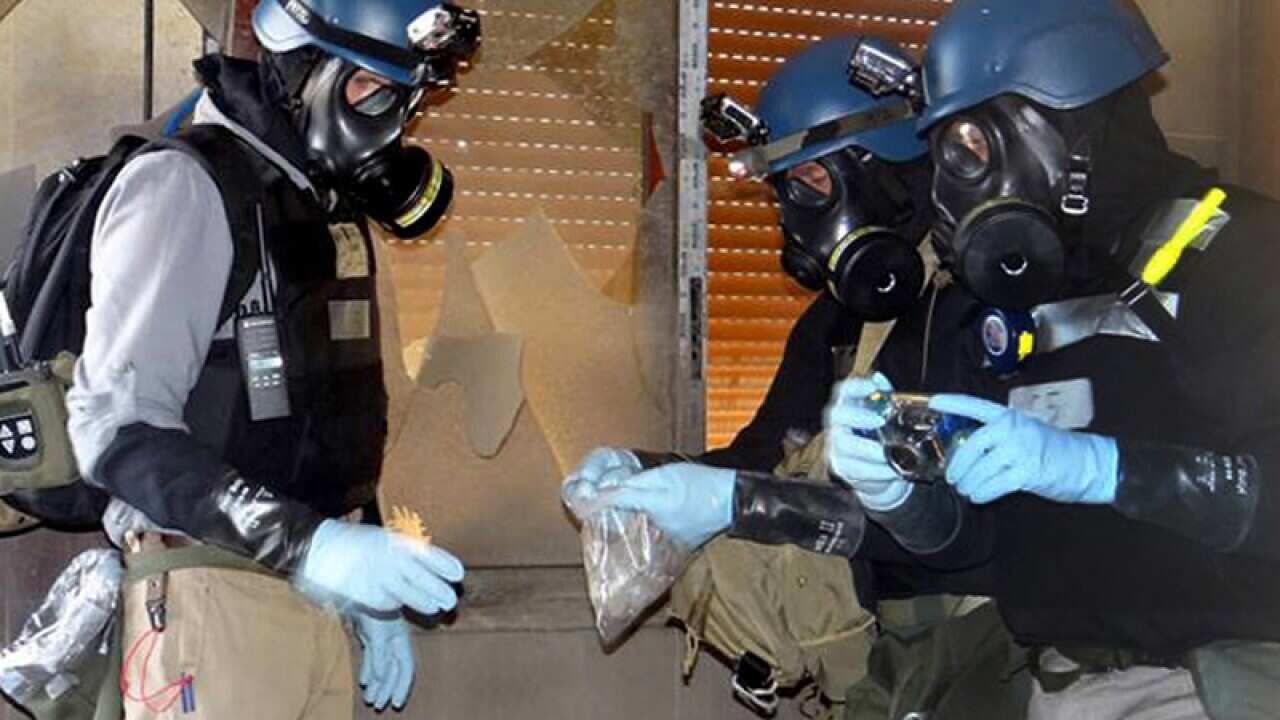 UN investigation team members taking samples