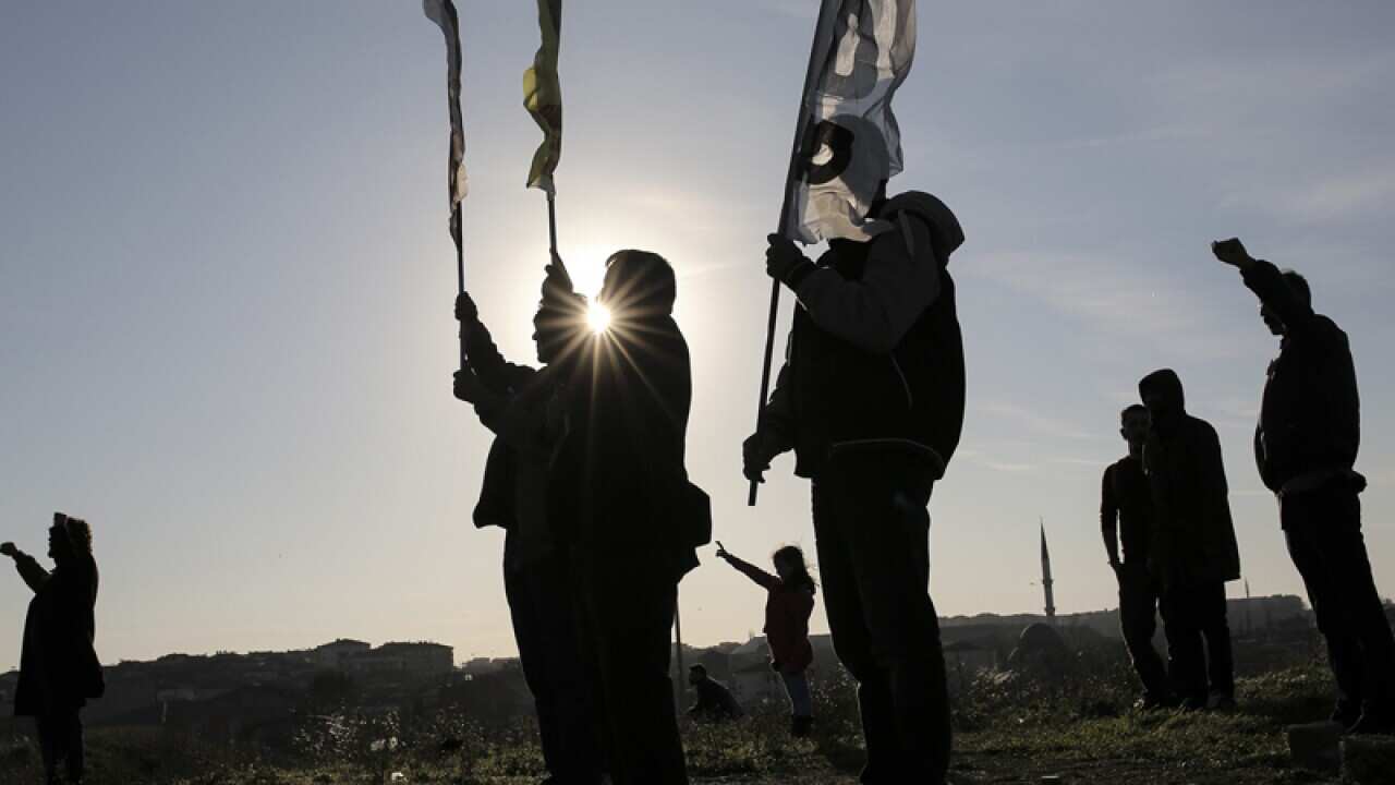Mourners participate in a funeral procession for a Turkish Kurd