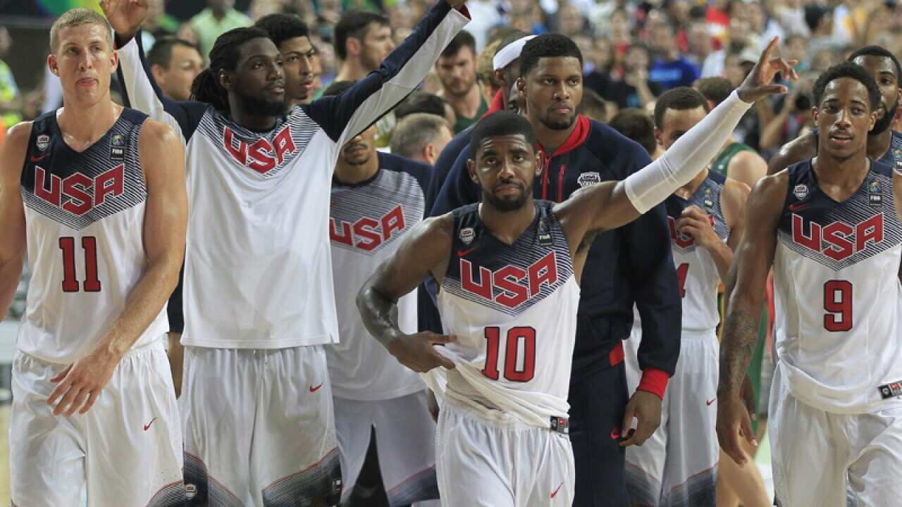 The USA basketball team celebrates after defeating Lithuania.