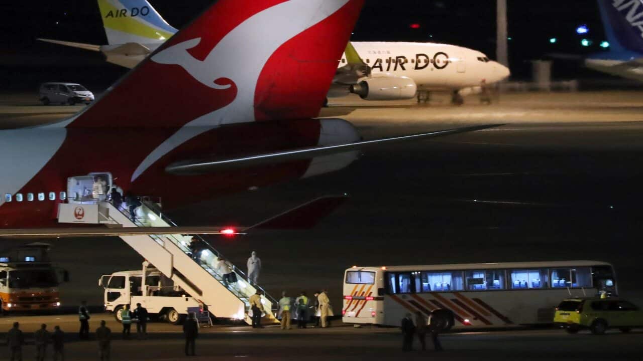 Passengers from the Diamond Princess board a Qantas airplane at Haneda airport