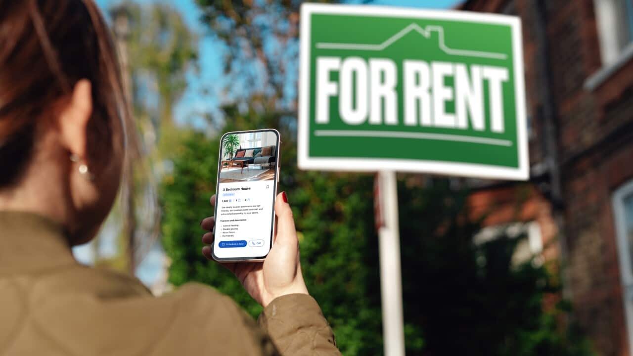 Woman looking for property to rent via real estate online platform on smartphone
