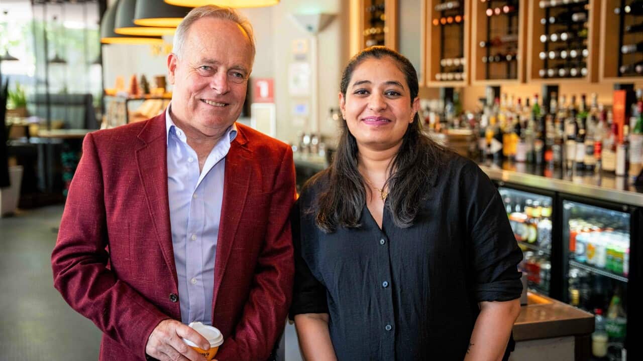 Song Hotel general manager Jon Ackary (left) with YWCA's Pooja (SBS).jpg