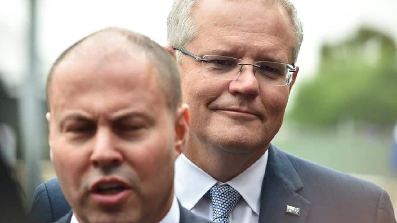 Treasurer Josh Frydenberg (l) and Prime Minister Scott Morrison