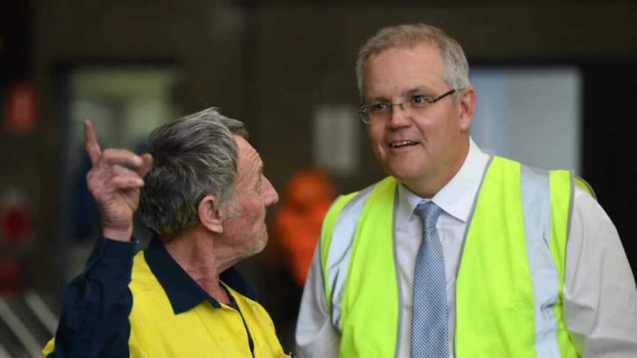Australian Prime Minister Scott Morrison (right) talks to employee Michael Sheridan (left) during a visit to steel manufacturing business Galvatech