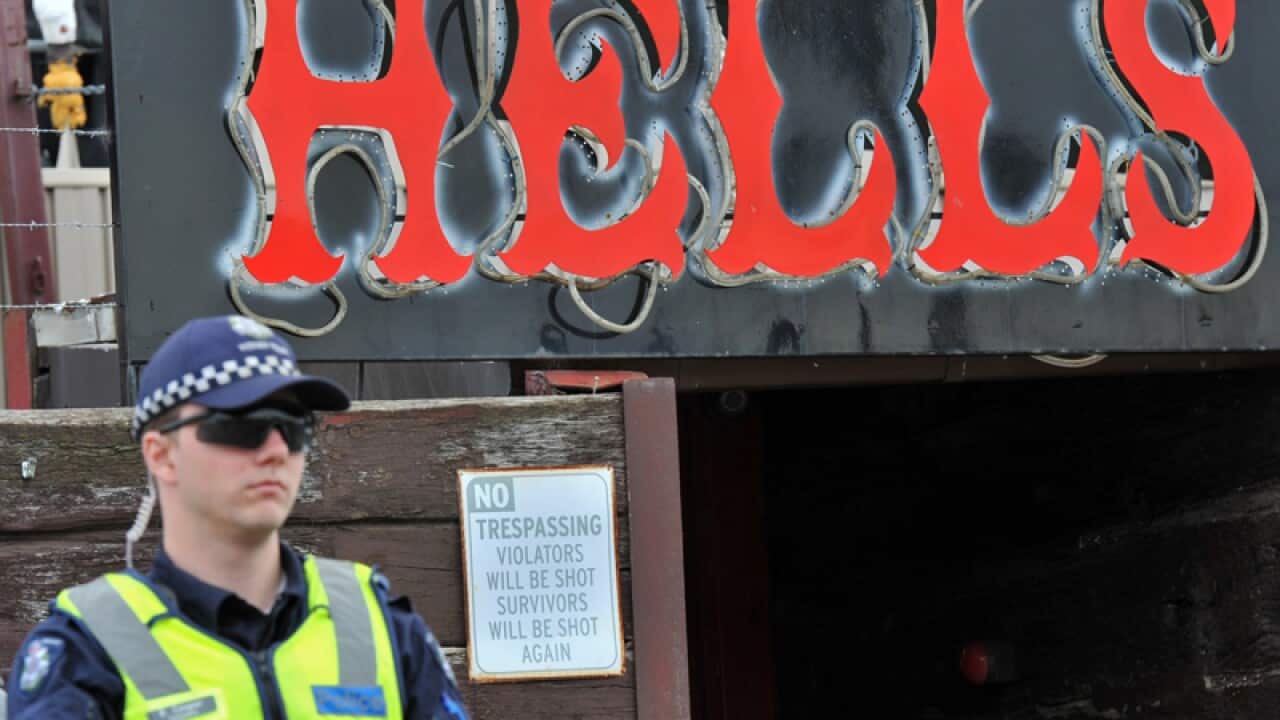 A police officer stands guard outside a Hells Angels club house