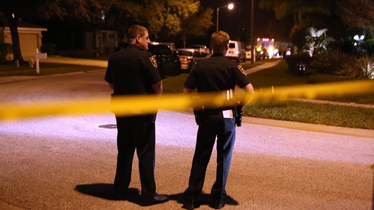 Police stand near an East Lake, Fla., home, where a two-year-old child died from a self-inflicted gunshot wound, Wed, Jan. 21, 2015 (AP/The Tampa Bay Times, Douglas R. Clifford)