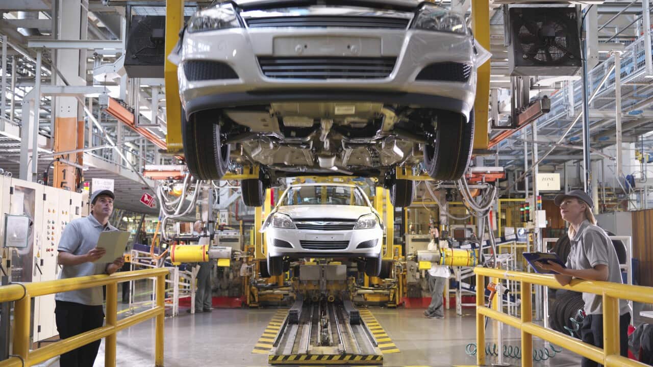 Car Workers Inspecting Production Line