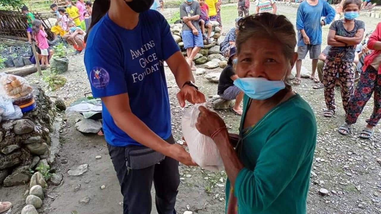 Mangyan woman receiving some food packs