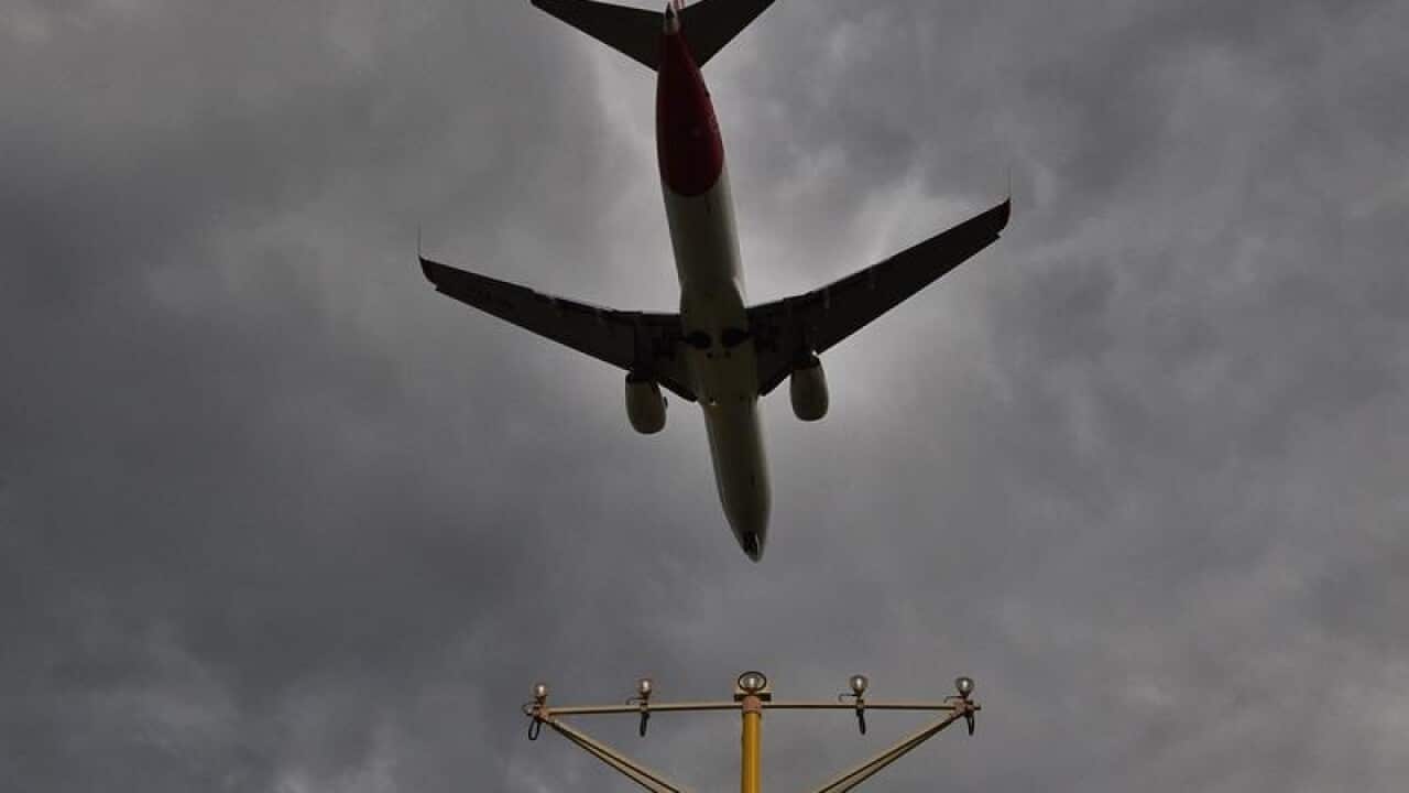 A passenger plane prepares to land at Sydney Airport.