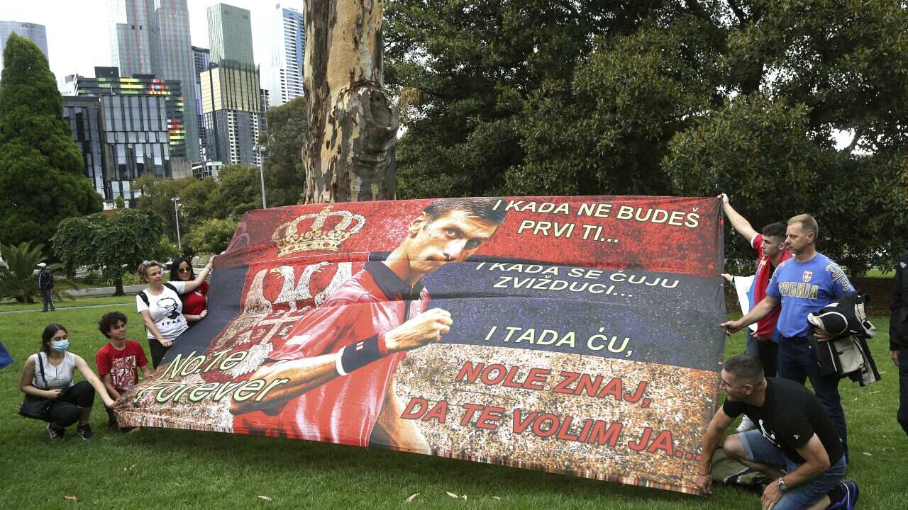 Protestors outside the Park Hotel in the Melbourne suburb of Carlton ahead of the Australian Open in Melbourne where it is believed Serbia Novak Djokovic is currently being detained, Australia, Friday, Jan. 7, 2022. Djokovic had received the medical exemp