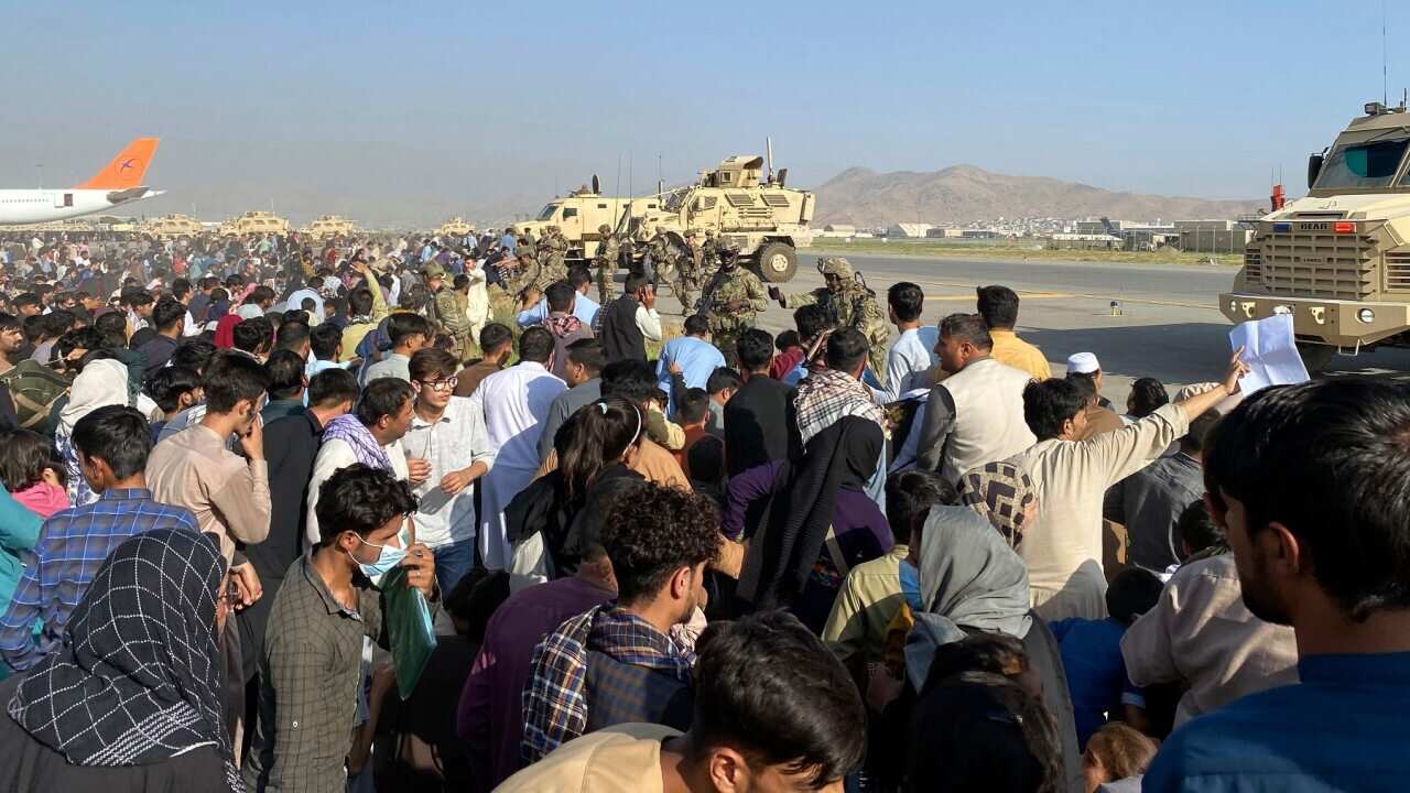 U.S soldiers stand guard along a perimeter at the international airport in Kabul