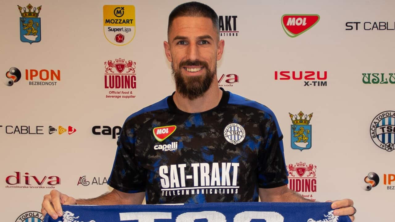Socceroo Milos Degenek poses with FC TSC jersey and scarf after signing for the Serbian outfit