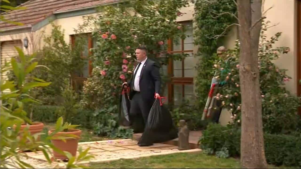 AFP agents leaving with evidence bags.