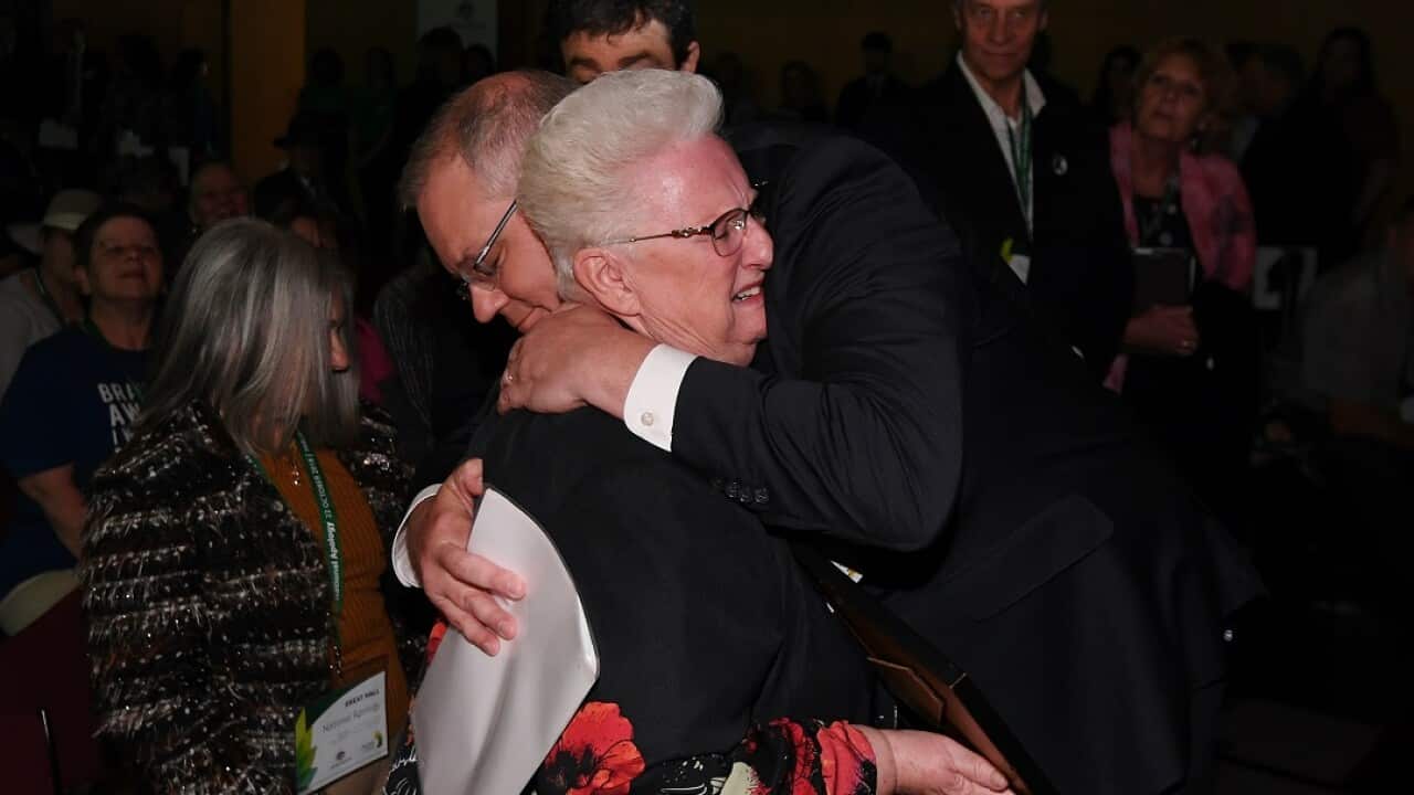 Prime Minister Scott Morrison hugs an abuse survivor after delivering the national apology. 