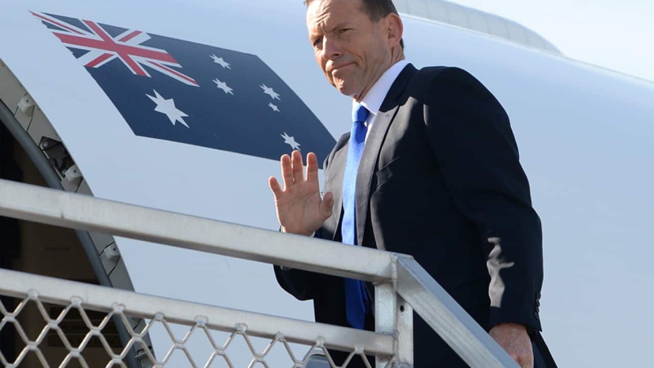 PM Tony Abbott boards a RAAF jet as he departs for Indonesia