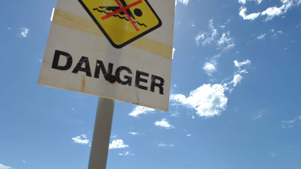 A danger sign at a beach.