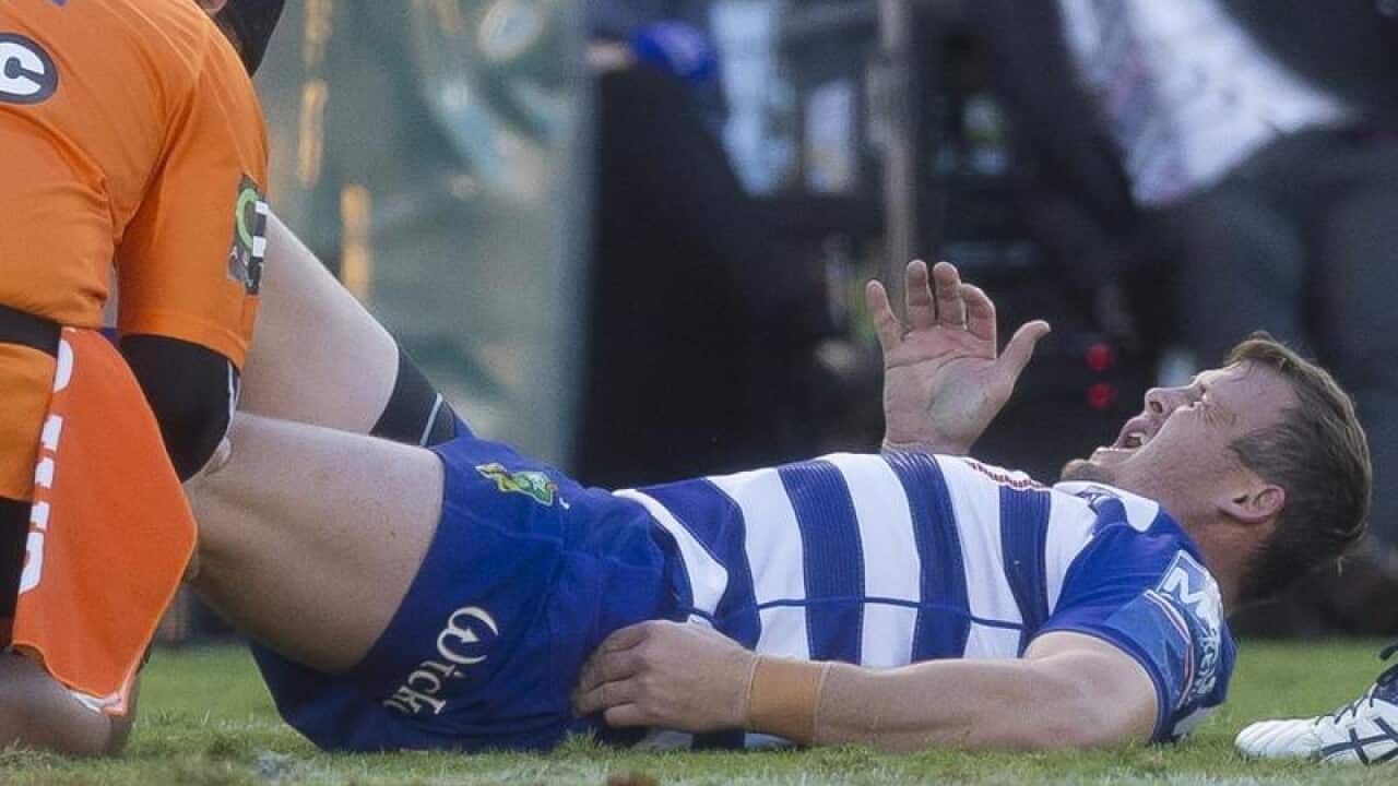 Joshua Morris of the Bulldogs is injured during Round 11.