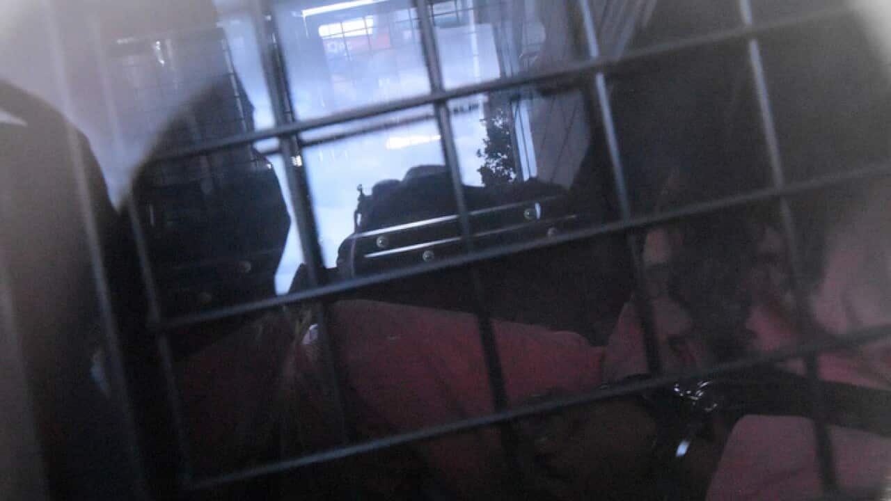 Belal Betka is seen in a prison van leaving Bankstown Local Court, Sydney