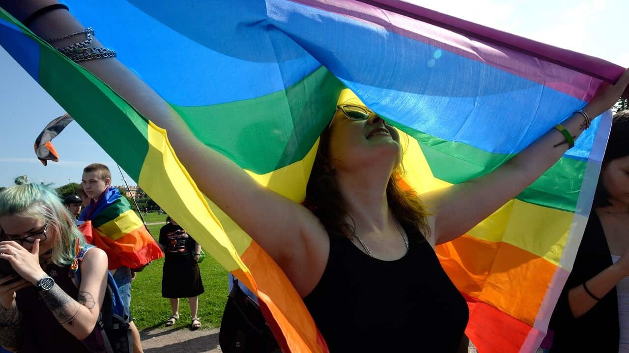 A woman holds the gay rights' movement rainbow flag during the gay pride rally in Saint Petersburg, on Agust 12, 2017. / AFP PHOTO / OLGA MALTSEVA (Photo credit should read OLGA MALTSEVA/AFP/Getty Images)