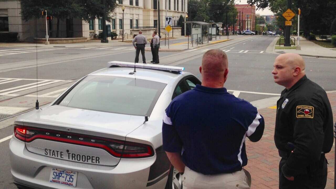 Law enforcement officers gather outside police headquarters in Charlotte, N.C., on Tuesday, Sept. 27, 2016, 