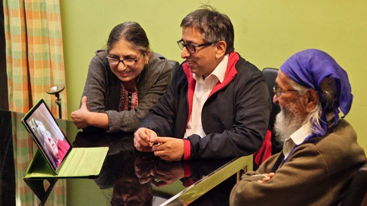 (L-R) Neerja and Jatinder Ahuja with Jatinders dad speak to family in Delhi