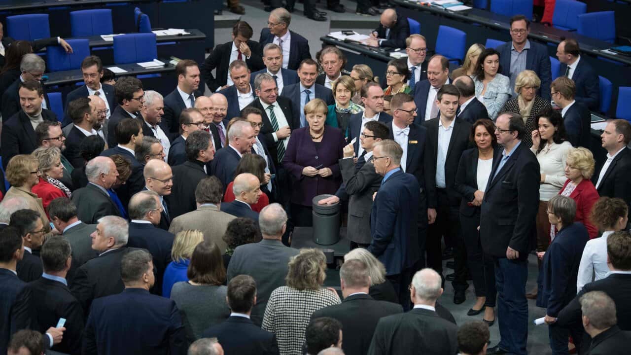 Chancellor Angela Merkel, center, and delegates voted on a new climate-protection law on Friday.Credit...