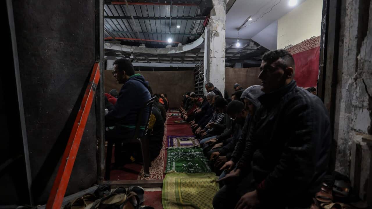 Palestinians say Tarawih prayers in the rubble of Al-Huda Mosque in Rafah (Getty)