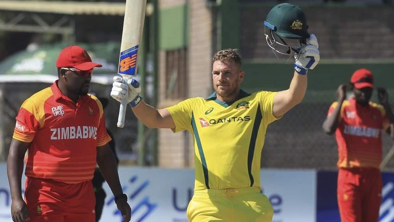 Australian batsman Aaron Finch celebrates scoring 100