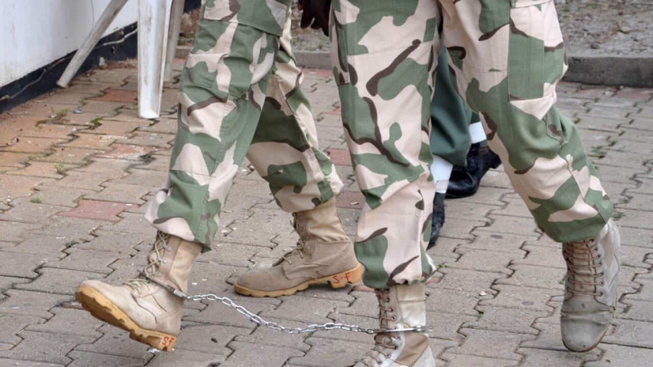 Nigerian soldiers in leg cuffs appear before a court martial