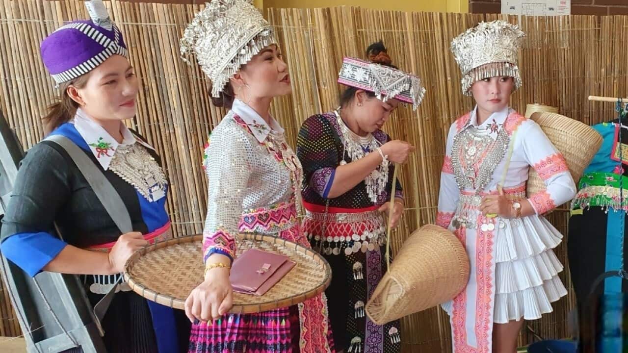 Hmong women dressed up in Hmong costomes carring traditional tools during Hmong Victoria New Year 2020 (SBS Hmong).jpg