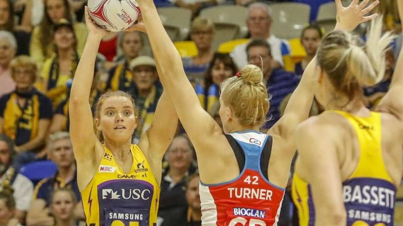 Stephanie Wood of the Lightning with the ball against Swifts.